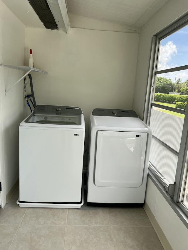 267 Flanders F, Delray Beach, FL 33484 - washroom with washer and clothes dryer and light tile patterned floors