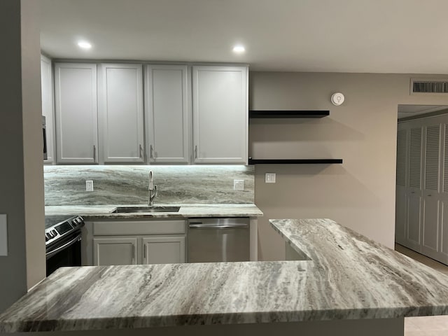 267 Flanders F, Delray Beach, FL 33484 - kitchen with open shelves, stainless steel dishwasher, electric range oven, light stone countertops, and recessed lighting