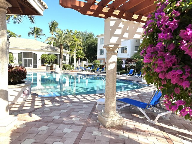 5205 Myrtlewood Cir E, Palm Beach Gardens, FL 33418 - community pool with a patio and a pergola
