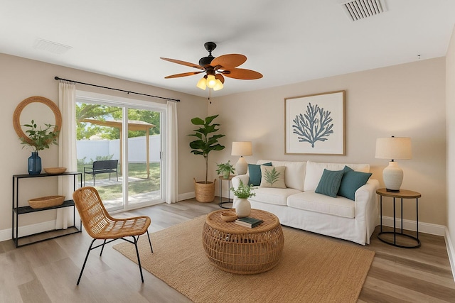 1413 Amaryllis Ln, West Palm Beach, FL 33415 - living room featuring baseboards, light wood-style flooring, and a ceiling fan
