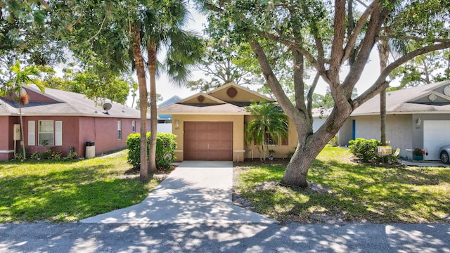 1413 Amaryllis Ln, West Palm Beach, FL 33415 - view of front of property featuring concrete driveway, a front yard, a garage, and stucco siding