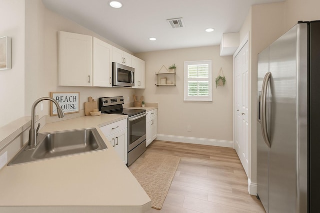 1413 Amaryllis Ln, West Palm Beach, FL 33415 - kitchen with appliances with stainless steel finishes, a sink, white cabinetry, light countertops, and baseboards
