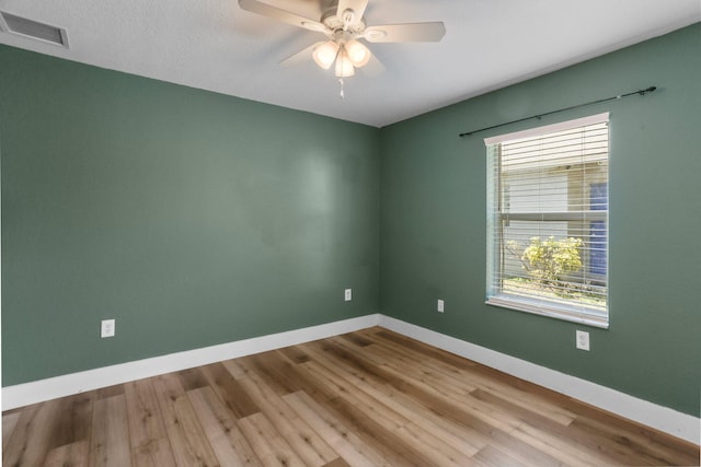 1413 Amaryllis Ln, West Palm Beach, FL 33415 - empty room with healthy amount of natural light, wood finished floors, baseboards, and a ceiling fan