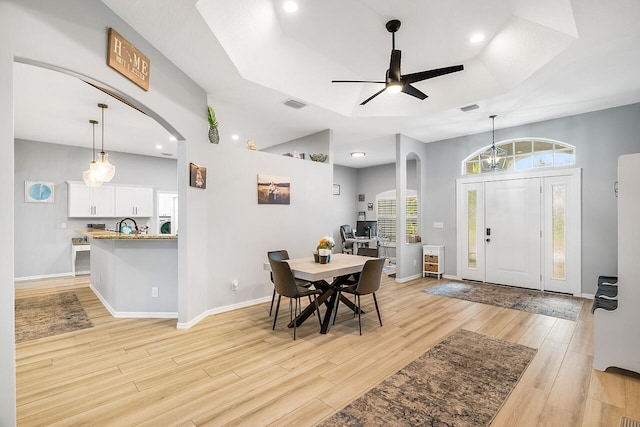 1025 Whitetail Ave SW, Vero Beach, FL 32968 - dining room with arched walkways, light wood-style flooring, a ceiling fan, recessed lighting, and baseboards