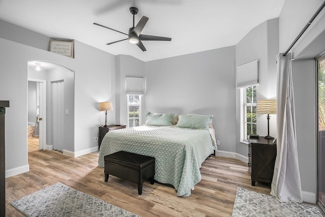 1025 Whitetail Ave SW, Vero Beach, FL 32968 - bedroom featuring arched walkways, wood finished floors, baseboards, and a ceiling fan