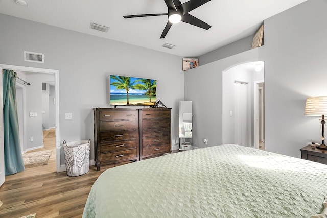 1025 Whitetail Ave SW, Vero Beach, FL 32968 - bedroom with arched walkways, wood finished floors, and a ceiling fan