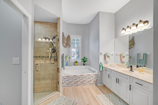 1025 Whitetail Ave SW, Vero Beach, FL 32968 - full bath with a shower stall, a garden tub, double vanity, and wood finished floors