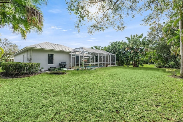1025 Whitetail Ave SW, Vero Beach, FL 32968 - view of green lawn featuring a swimming pool and a lanai