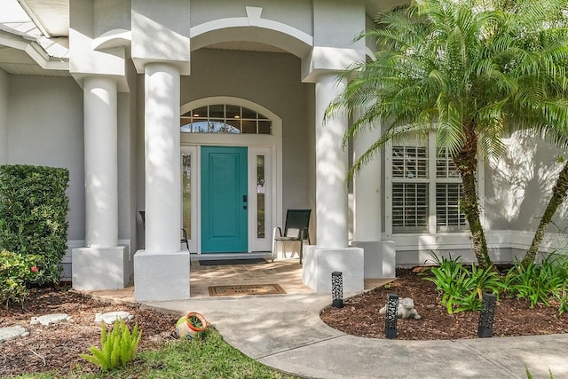 1025 Whitetail Ave SW, Vero Beach, FL 32968 - view of exterior entry with covered porch and stucco siding