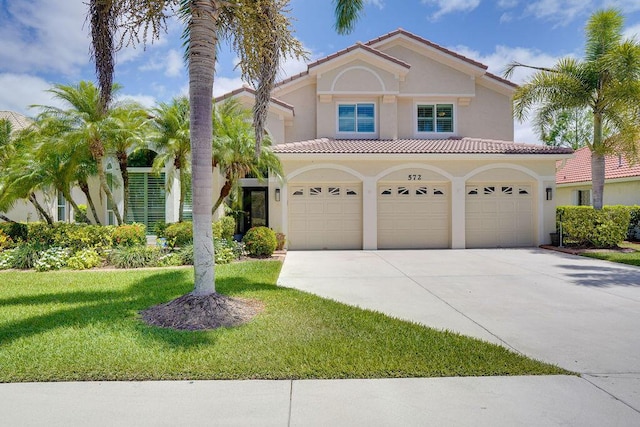572 SW Romora Bay, Port Saint Lucie, FL 34986 - mediterranean / spanish-style home featuring stucco siding, driveway, a front yard, and a tile roof