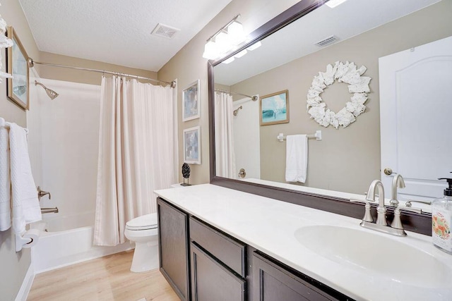 572 SW Romora Bay, Port Saint Lucie, FL 34986 - bathroom featuring toilet, wood finished floors, shower / bath combo with shower curtain, and vanity