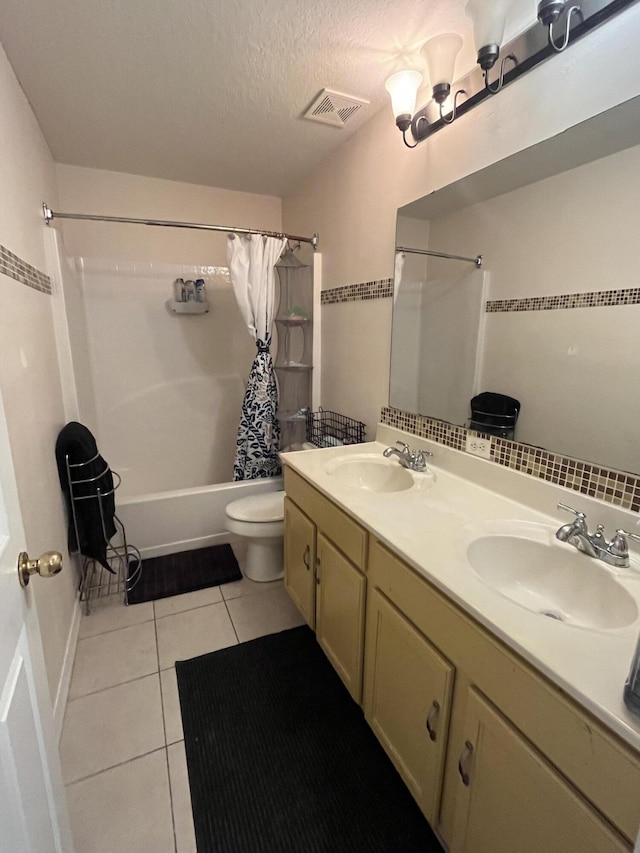 991 SE Bywood Ave, Port Saint Lucie, FL 34983 - full bath featuring tile patterned flooring, shower / bath combo, toilet, double vanity, and a textured ceiling