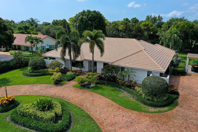 4164 Saint Andrews Dr, Boynton Beach, FL 33436 - view of front of home featuring a tiled roof, stucco siding, a front lawn, and curved driveway