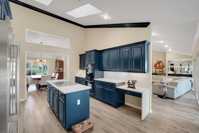4164 Saint Andrews Dr, Boynton Beach, FL 33436 - kitchen with crown molding, blue cabinets, a skylight, black appliances, and a chandelier