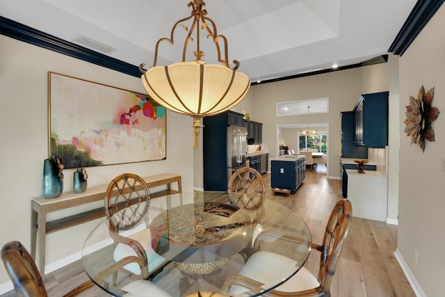 4164 Saint Andrews Dr, Boynton Beach, FL 33436 - dining room with a chandelier, light wood-type flooring, and a raised ceiling