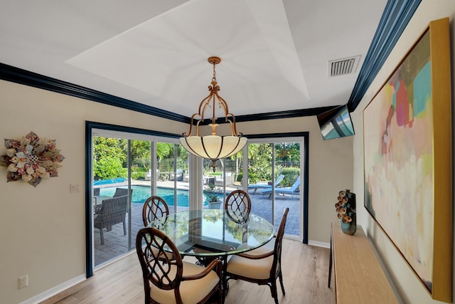 4164 Saint Andrews Dr, Boynton Beach, FL 33436 - dining area with a chandelier, light wood-style floors, and ornamental molding
