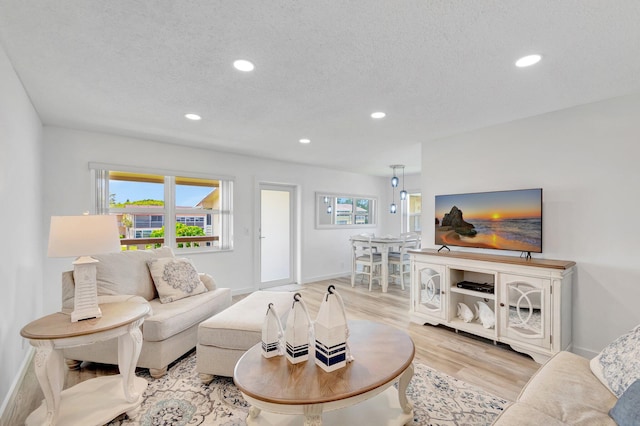 229 Chatham K, West Palm Beach, FL 33417 - living room with light wood-type flooring, recessed lighting, healthy amount of natural light, baseboards, and a textured ceiling