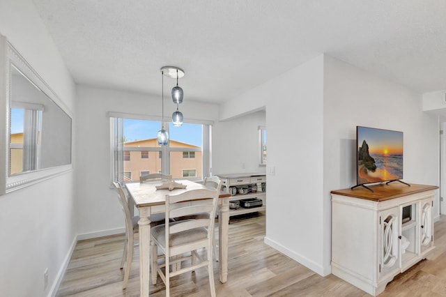 229 Chatham K, West Palm Beach, FL 33417 - dining room featuring baseboards and light wood-style floors