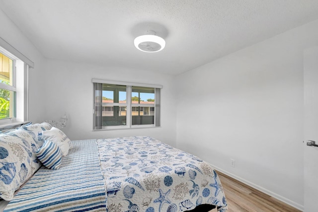 229 Chatham K, West Palm Beach, FL 33417 - bedroom with wood finished floors, baseboards, and a textured ceiling