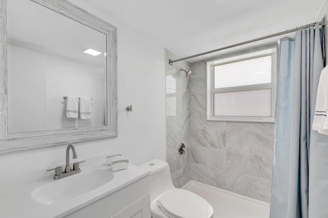 229 Chatham K, West Palm Beach, FL 33417 - bathroom featuring tiled shower, toilet, and vanity