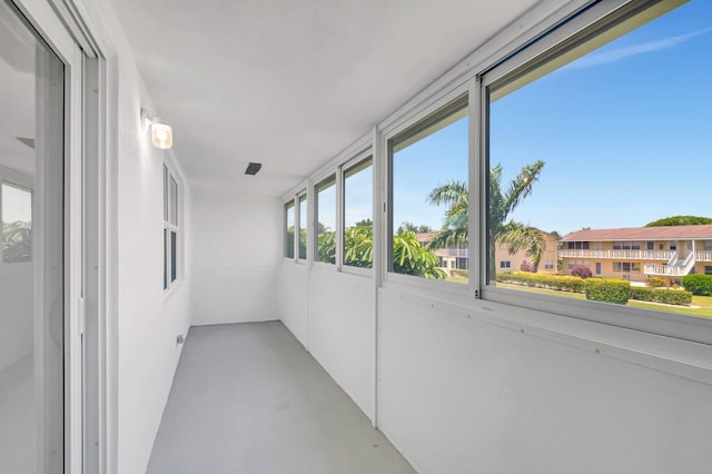 229 Chatham K, West Palm Beach, FL 33417 - unfurnished sunroom with concrete floors
