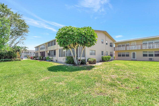 229 Chatham K, West Palm Beach, FL 33417 - back of property featuring a yard and stucco siding