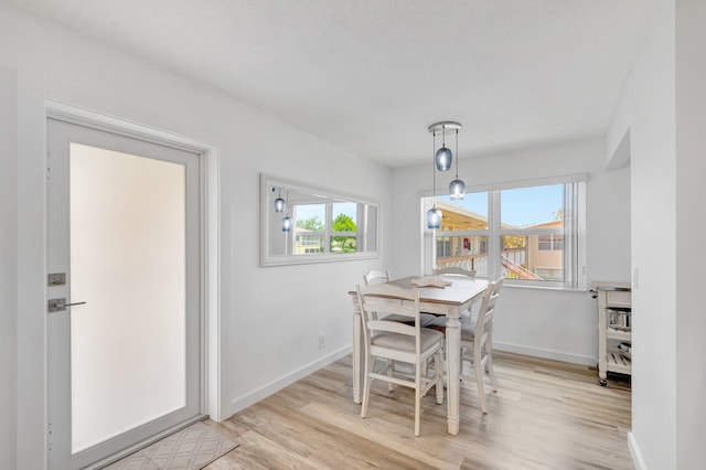 229 Chatham K, West Palm Beach, FL 33417 - dining space featuring healthy amount of natural light, baseboards, and light wood-style flooring