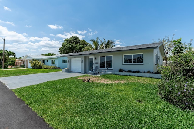 7307 NW 58th Ct, Tamarac, FL 33321 - ranch-style house featuring a garage, driveway, stucco siding, and a front lawn
