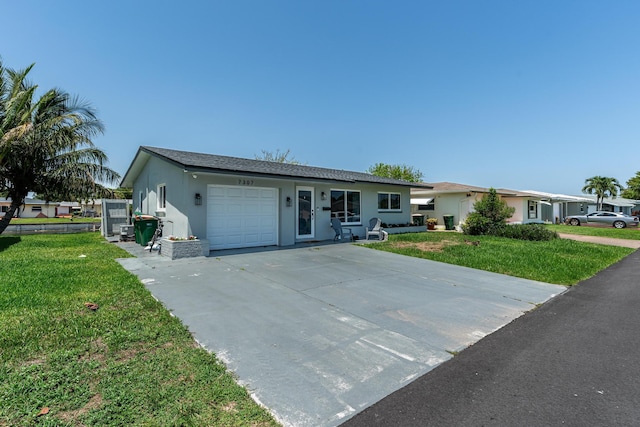 7307 NW 58th Ct, Tamarac, FL 33321 - single story home with an attached garage, a front yard, stucco siding, and driveway
