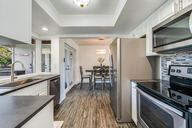 7307 NW 58th Ct, Tamarac, FL 33321 - kitchen featuring stainless steel appliances, a sink, dark countertops, and backsplash