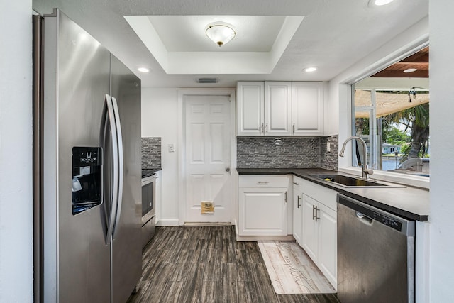 7307 NW 58th Ct, Tamarac, FL 33321 - kitchen featuring appliances with stainless steel finishes, a sink, dark wood finished floors, white cabinetry, and recessed lighting