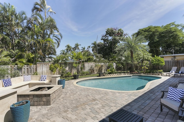501 SE 13th Ct, Pompano Beach, FL 33060 - view of swimming pool with a patio, a fire pit, and a fenced backyard