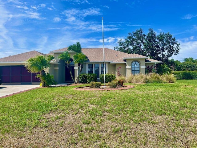 3103 SE Mall Ter S, Port Saint Lucie, FL 34984 - view of front of home featuring a garage, stucco siding, concrete driveway, and a front lawn