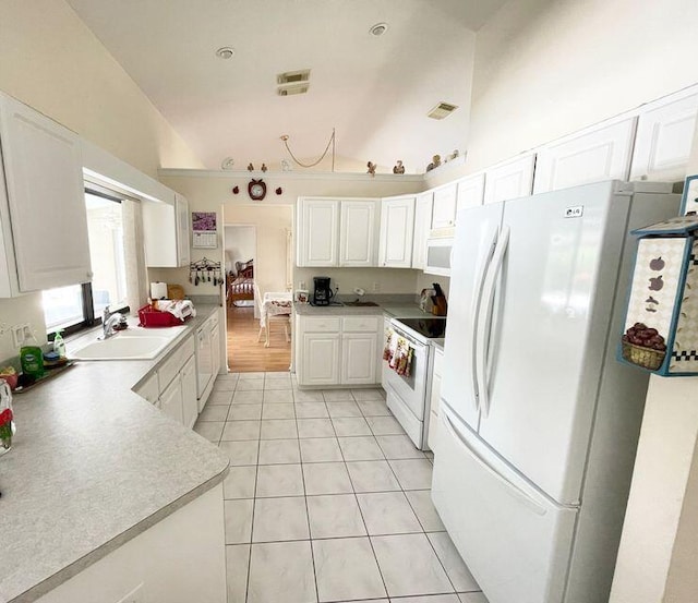 3103 SE Mall Ter S, Port Saint Lucie, FL 34984 - kitchen with white appliances, a sink, light tile patterned floors, white cabinetry, and light countertops