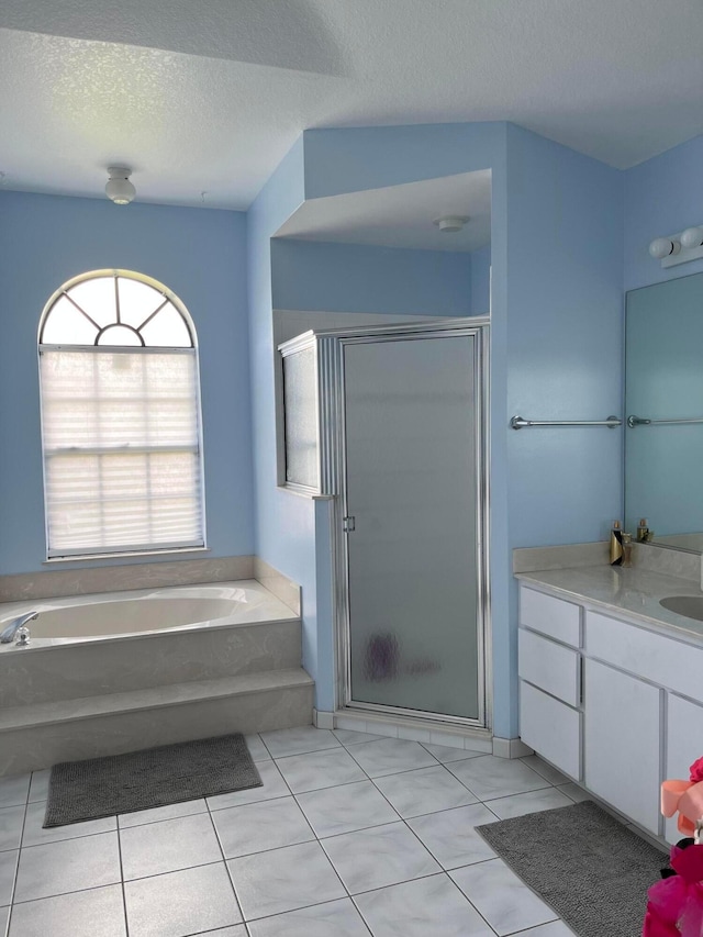 3103 SE Mall Ter S, Port Saint Lucie, FL 34984 - bathroom featuring tile patterned flooring, a textured ceiling, vanity, a bath, and a stall shower
