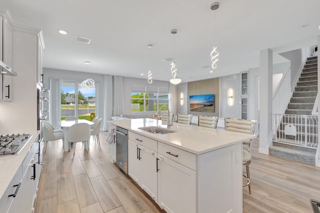 5322 Yellow Water Lily Ct, Lake Worth, FL 33467 - kitchen featuring a sink, stainless steel appliances, white cabinets, light countertops, and light wood finished floors