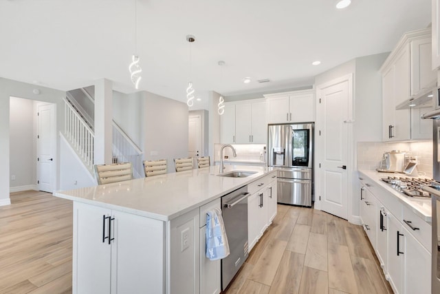 5322 Yellow Water Lily Ct, Lake Worth, FL 33467 - kitchen with stainless steel appliances, a sink, light wood finished floors, tasteful backsplash, and recessed lighting