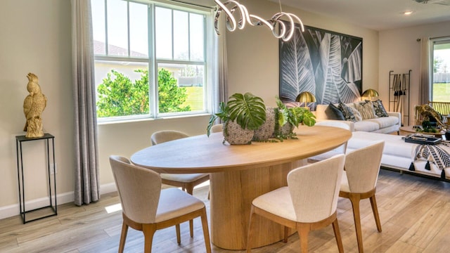 1553 SE Crosswood Way, Port Saint Lucie, FL 34984 - dining room featuring light wood-style flooring, a chandelier, baseboards, and recessed lighting