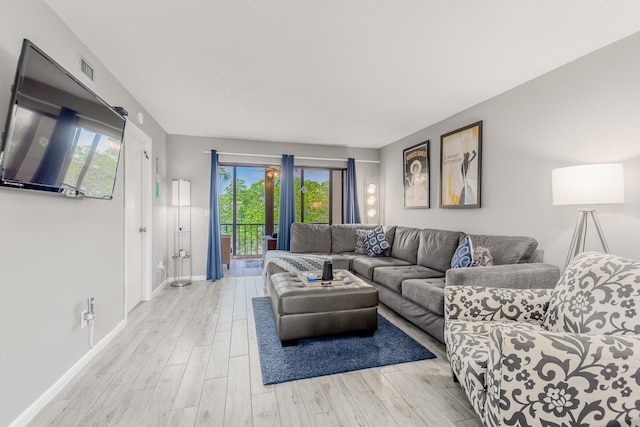 390 NE Edgewater Dr Unit 302, Stuart, FL 34996 - living room with light wood-style flooring and baseboards