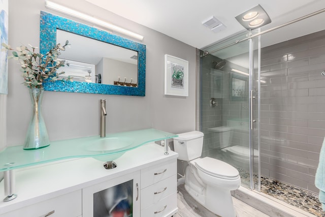 390 NE Edgewater Dr Unit 302, Stuart, FL 34996 - bathroom featuring toilet, a shower stall, vanity, and wood finished floors