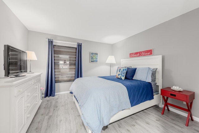 390 NE Edgewater Dr Unit 302, Stuart, FL 34996 - bedroom featuring light wood-style floors and baseboards
