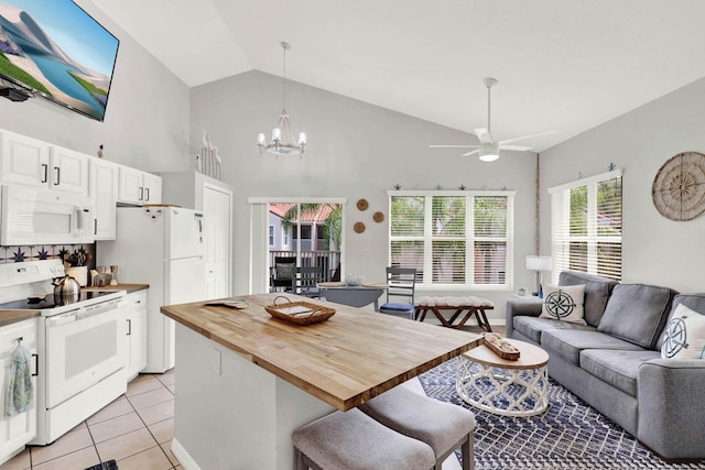 9927 Perfect Dr Unit 108, Port Saint Lucie, FL 34986 - kitchen with white appliances, wooden counters, open floor plan, light tile patterned floors, and ceiling fan