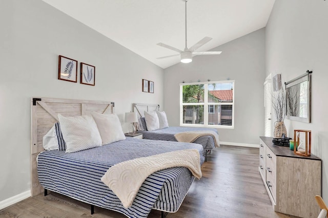 9927 Perfect Dr Unit 108, Port Saint Lucie, FL 34986 - bedroom featuring wood finished floors, baseboards, high vaulted ceiling, and ceiling fan