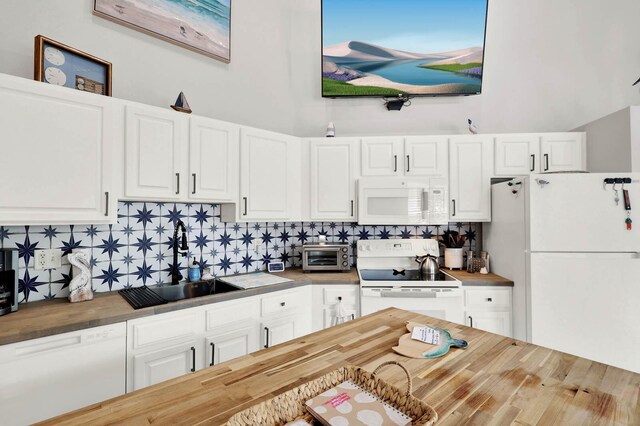 9927 Perfect Dr Unit 108, Port Saint Lucie, FL 34986 - kitchen featuring white appliances, wood counters, tasteful backsplash, and white cabinets