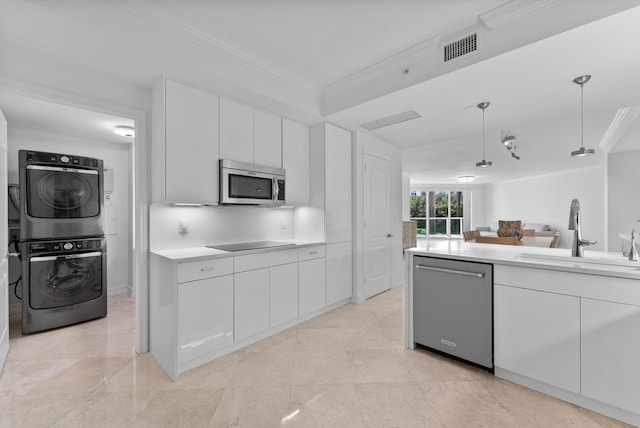 550 SE Mizner Blvd Unit B206, Boca Raton, FL 33432 - kitchen featuring appliances with stainless steel finishes, stacked washer / dryer, a sink, ornamental molding, and light countertops