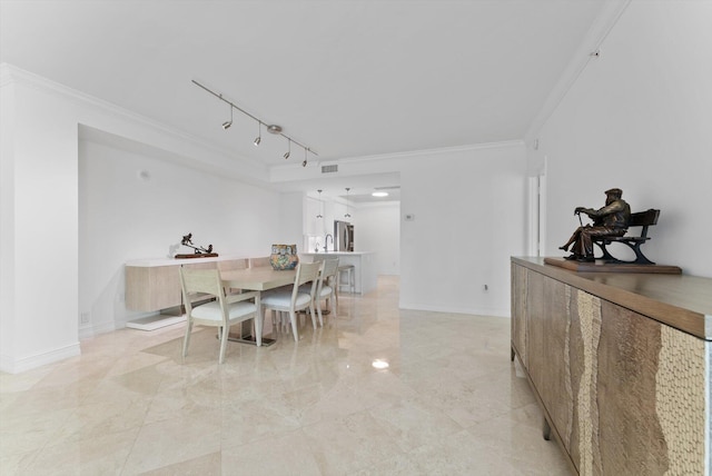 550 SE Mizner Blvd Unit B206, Boca Raton, FL 33432 - dining room featuring crown molding, rail lighting, baseboards, and light marble finish flooring
