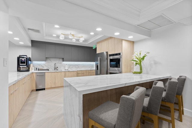550 SE Mizner Blvd Unit B206, Boca Raton, FL 33432 - kitchen featuring modern cabinets, appliances with stainless steel finishes, light brown cabinets, ornamental molding, and recessed lighting
