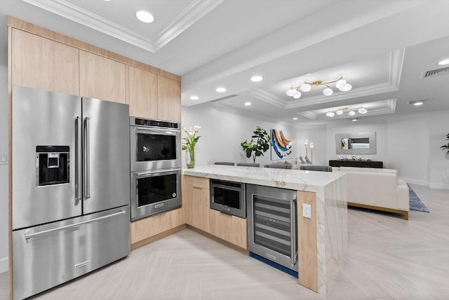 550 SE Mizner Blvd Unit B206, Boca Raton, FL 33432 - kitchen with appliances with stainless steel finishes, light brown cabinets, beverage cooler, a tray ceiling, and crown molding