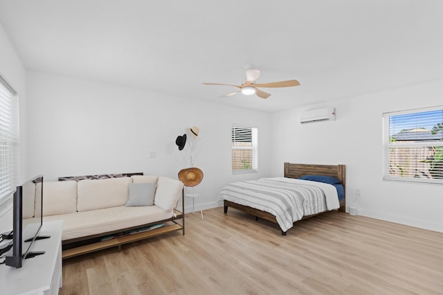1517 NW 12th Ave, Fort Lauderdale, FL 33311 - bedroom with a wall mounted AC, multiple windows, and light wood finished floors