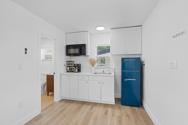 1517 NW 12th Ave, Fort Lauderdale, FL 33311 - kitchen featuring black microwave, a sink, refrigerator, light wood-style flooring, and healthy amount of natural light